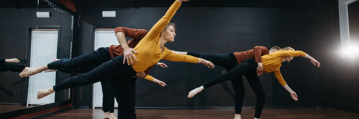Dancers holding a synchronized pose in a studio