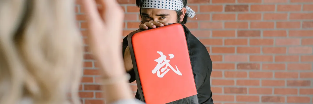Student striking a focus pad during dojo training